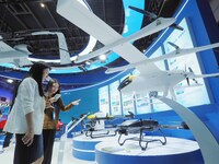 Visitors visit the ''hanging Compound Wing unmanned transport aircraft'' at the HICOOL 2024 Global Entrepreneurs Summit in Beijing, China, o...