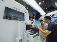 Visitors visit the ''Brain Loop Pacemaker'' at the HICOOL 2024 Global Entrepreneurs Summit in Beijing, China, on August 23, 2024. (