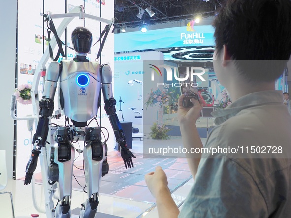 Visitors visit a ''humanoid robot'' at the HICOOL 2024 Global Entrepreneurs Summit in Beijing, China, on August 23, 2024. 