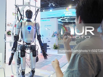 Visitors visit a ''humanoid robot'' at the HICOOL 2024 Global Entrepreneurs Summit in Beijing, China, on August 23, 2024. (