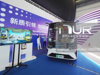 Visitors visit a ''self-driving bus'' at the HICOOL 2024 Global Entrepreneurs Summit in Beijing, China, on August 23, 2024. (