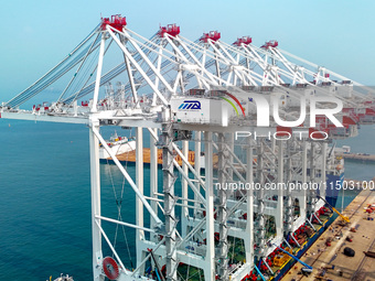 The first five ultra-large shore cranes are sent to Egypt at the West Coast New Area in Qingdao, Shandong province, China, on August 23, 202...