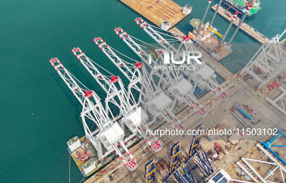 The first five ultra-large shore cranes are sent to Egypt at the West Coast New Area in Qingdao, Shandong province, China, on August 23, 202...