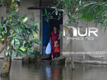 Local residents shift to temporary shelter homes as floodwater rises in their homes in Feni, Chittagong, Bangladesh, on August 23, 2024. (