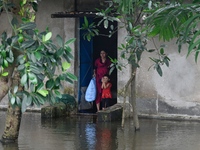 Local residents shift to temporary shelter homes as floodwater rises in their homes in Feni, Chittagong, Bangladesh, on August 23, 2024. (