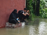 People are stuck due to floodwater in the rail track area in Feni, Chittagong, Bangladesh, on August 23, 2024. (