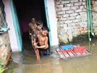 Local residents shift to temporary shelter homes as floodwater rises in their homes in Feni, Chittagong, Bangladesh, on August 23, 2024. (