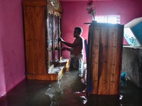 Local residents shift to temporary shelter homes as floodwater rises in their homes in Feni, Chittagong, Bangladesh, on August 23, 2024. (