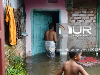 Local residents shift to temporary shelter homes as floodwater rises in their homes in Feni, Chittagong, Bangladesh, on August 23, 2024. (