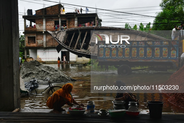 Volunteers carry a boat on a truck to help flood-affected people in Feni, Chittagong, Bangladesh, on August 23, 2024. 