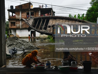 Volunteers carry a boat on a truck to help flood-affected people in Feni, Chittagong, Bangladesh, on August 23, 2024. (