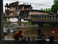 Volunteers carry a boat on a truck to help flood-affected people in Feni, Chittagong, Bangladesh, on August 23, 2024. (