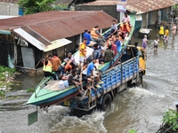 Volunteers carry a boat on a truck to help flood-affected people in Feni, Chittagong, Bangladesh, on August 23, 2024. (