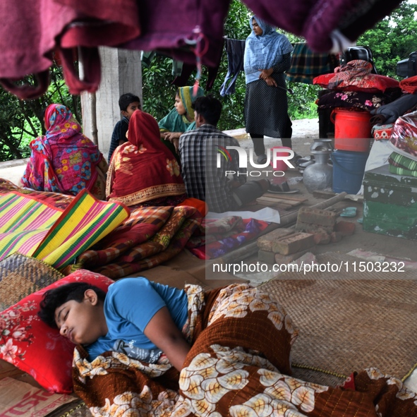 Flood-affected people take shelter in an under-construction building in Feni, Chittagong, Bangladesh, on August 23, 2024. 