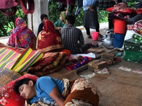 Flood-affected people take shelter in an under-construction building in Feni, Chittagong, Bangladesh, on August 23, 2024. (