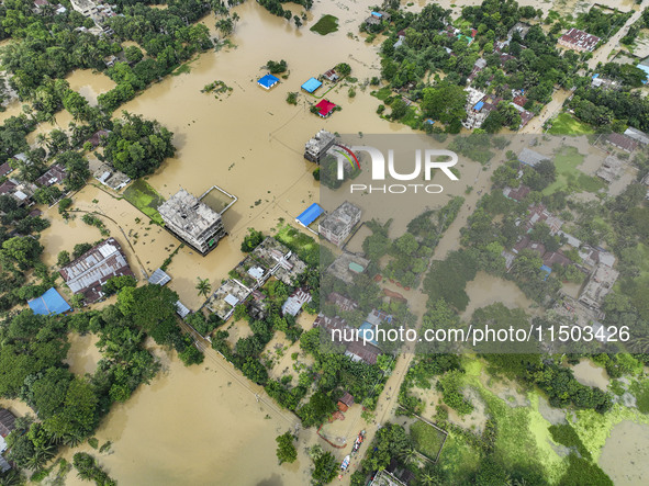 An aerial view shows flooded villages in the Mohipal area of Feni district in Chittagong division, Bangladesh, on August 23, 2024. At least...