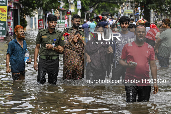 The Bangladesh Ansar personnel rescue two pregnant women in the Mohipal area of the Feni district in Chittagong division, Bangladesh, on Aug...