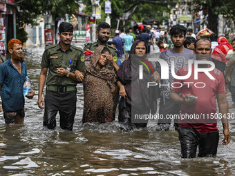 The Bangladesh Ansar personnel rescue two pregnant women in the Mohipal area of the Feni district in Chittagong division, Bangladesh, on Aug...