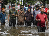 The Bangladesh Ansar personnel rescue two pregnant women in the Mohipal area of the Feni district in Chittagong division, Bangladesh, on Aug...