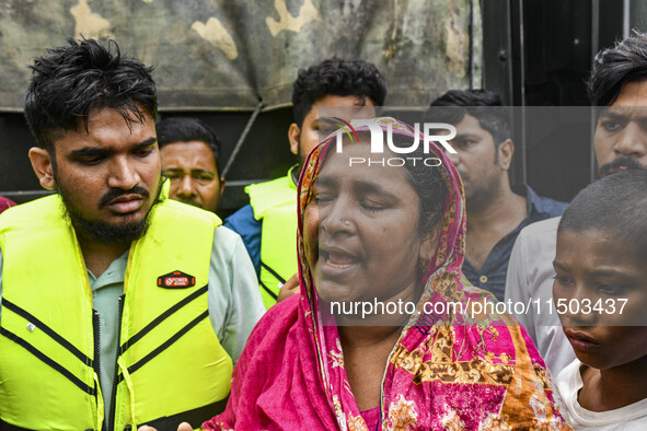 A relative cries because they cannot contact their relative, of flood-affected residents in the Mohipal area of the Feni district in Chittag...