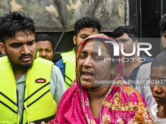 A relative cries because they cannot contact their relative, of flood-affected residents in the Mohipal area of the Feni district in Chittag...