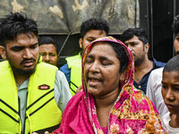 A relative cries because they cannot contact their relative, of flood-affected residents in the Mohipal area of the Feni district in Chittag...