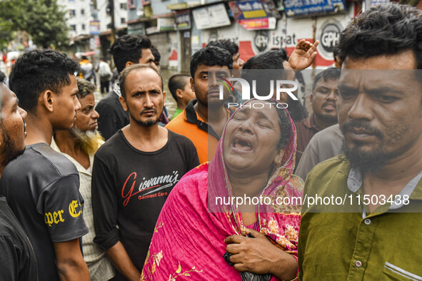 A relative cries because they cannot contact their relative, of flood-affected residents in the Mohipal area of the Feni district in Chittag...