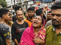 A relative cries because they cannot contact their relative, of flood-affected residents in the Mohipal area of the Feni district in Chittag...