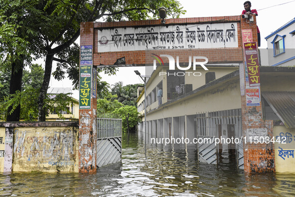 Flood-affected people take temporary shelter at a school building in the Mohipal area of Feni district in Chittagong division, Bangladesh, o...