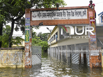 Flood-affected people take temporary shelter at a school building in the Mohipal area of Feni district in Chittagong division, Bangladesh, o...