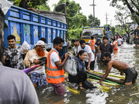 Volunteers rescue a flood-affected woman in the Mohipal area of Feni district in Chittagong division, Bangladesh, on August 23, 2024. At lea...