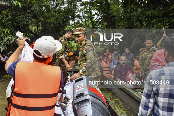 Bangladesh army personnel distribute relief material to the flooded areas in the Mohipal area of Feni district in Chittagong division, Bangl...