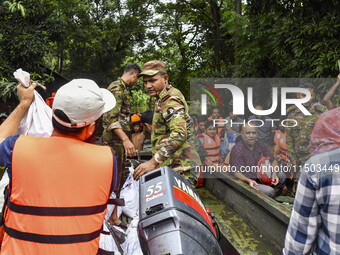 Bangladesh army personnel distribute relief material to the flooded areas in the Mohipal area of Feni district in Chittagong division, Bangl...