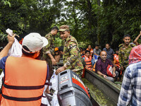 Bangladesh army personnel distribute relief material to the flooded areas in the Mohipal area of Feni district in Chittagong division, Bangl...