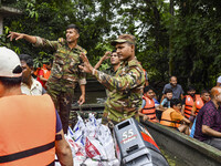 Bangladesh army personnel distribute relief material to the flooded areas in the Mohipal area of Feni district in Chittagong division, Bangl...