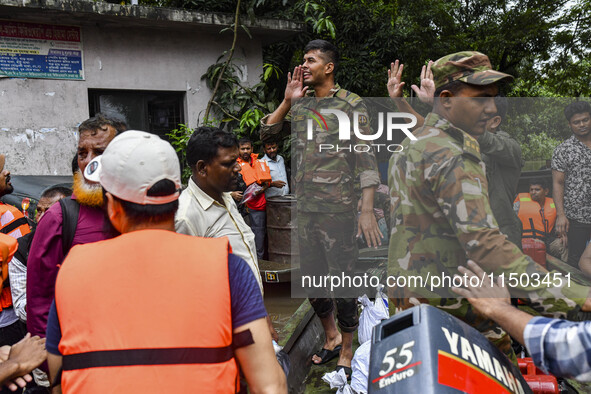 Bangladesh army personnel distribute relief material to the flooded areas in the Mohipal area of Feni district in Chittagong division, Bangl...