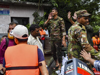 Bangladesh army personnel distribute relief material to the flooded areas in the Mohipal area of Feni district in Chittagong division, Bangl...