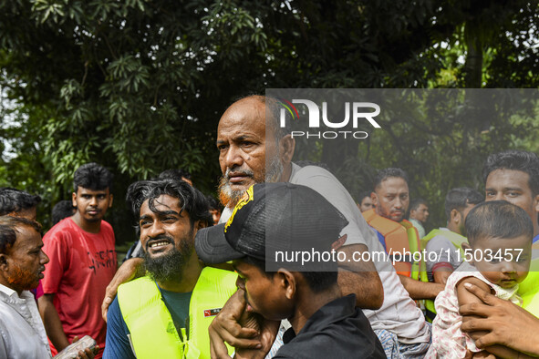 Volunteers rescue flood-affected residents in the Mohipal area of Feni district in Chittagong division, Bangladesh, on August 23, 2024. At l...