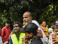 Volunteers rescue flood-affected residents in the Mohipal area of Feni district in Chittagong division, Bangladesh, on August 23, 2024. At l...