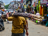 A man carries sugarcane in the Chalai market in Thiruvananthapuram, Kerala, India, on April 13, 2024. The Chalai Market (Chalai bazaar) is K...