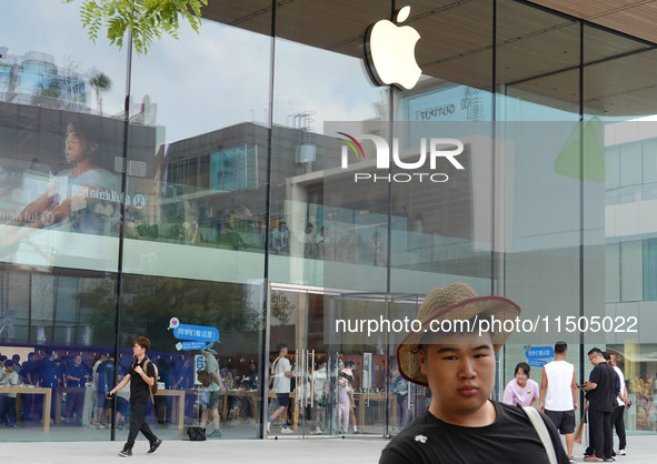 People experience products at the Apple flagship store at Taikoo Li in Sanlitun, a trendy fashion district in Beijing, China, on August 18,...