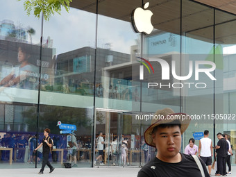 People experience products at the Apple flagship store at Taikoo Li in Sanlitun, a trendy fashion district in Beijing, China, on August 18,...