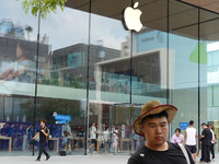 People experience products at the Apple flagship store at Taikoo Li in Sanlitun, a trendy fashion district in Beijing, China, on August 18,...