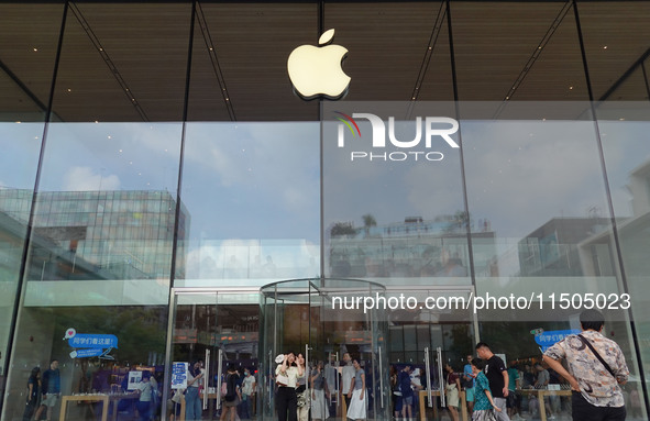 People experience products at the Apple flagship store at Taikoo Li in Sanlitun, a trendy fashion district in Beijing, China, on August 18,...