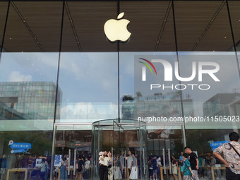 People experience products at the Apple flagship store at Taikoo Li in Sanlitun, a trendy fashion district in Beijing, China, on August 18,...