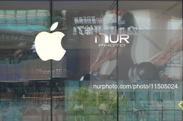 People experience products at the Apple flagship store at Taikoo Li in Sanlitun, a trendy fashion district in Beijing, China, on August 18,...