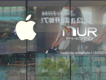 People experience products at the Apple flagship store at Taikoo Li in Sanlitun, a trendy fashion district in Beijing, China, on August 18,...