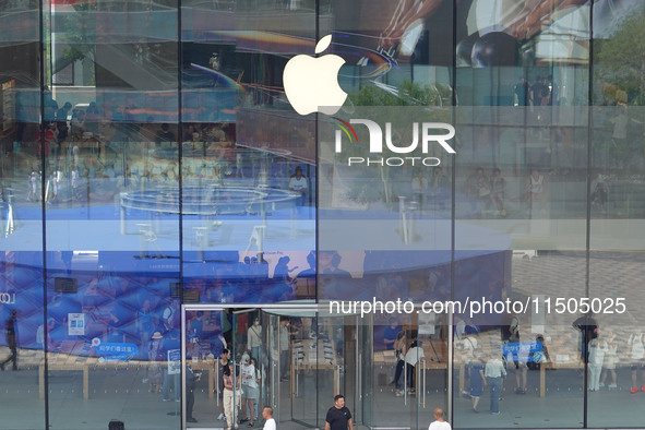 People experience products at the Apple flagship store at Taikoo Li in Sanlitun, a trendy fashion district in Beijing, China, on August 18,...