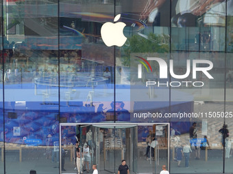 People experience products at the Apple flagship store at Taikoo Li in Sanlitun, a trendy fashion district in Beijing, China, on August 18,...