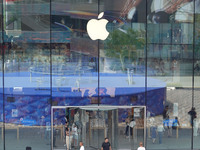 People experience products at the Apple flagship store at Taikoo Li in Sanlitun, a trendy fashion district in Beijing, China, on August 18,...